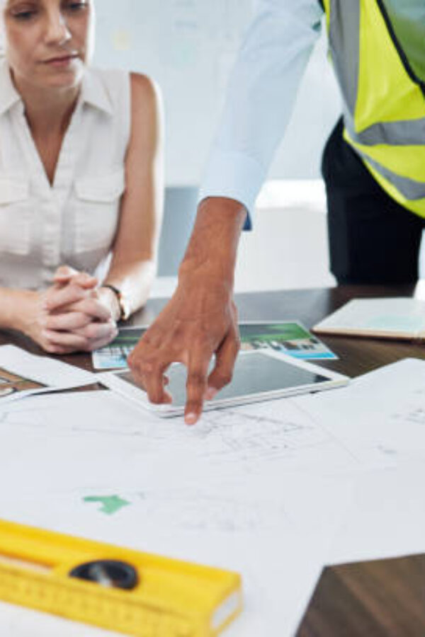 Construction, blueprint and planning with architect in meeting for consulting, project management and vision. Design, engineering and construction site plans with team of designers or contractors
